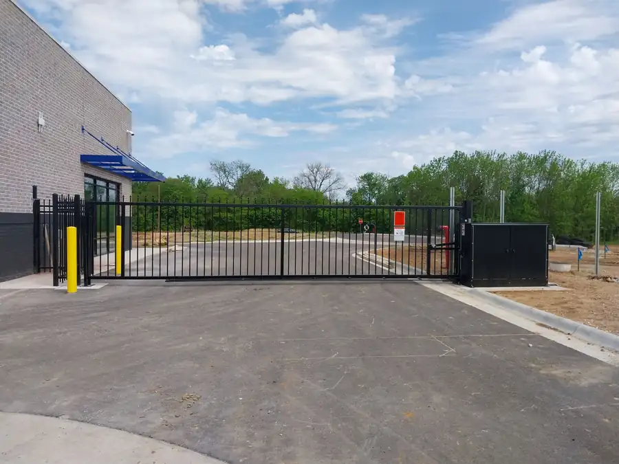 Black pivot security gate across the entrance of a Centerton self storage facility