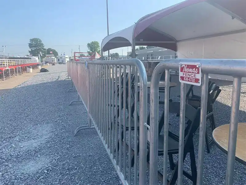 Galvanized temporary barricade panels lining an event lane in Springdale