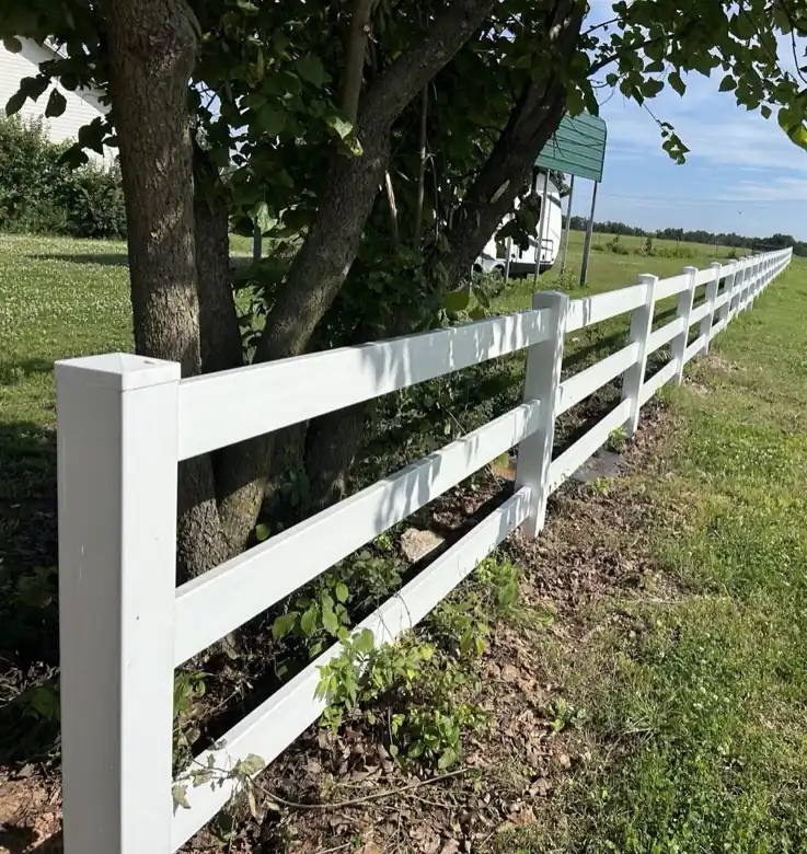 White three rail vinyl ranch fence along a field in Springdale